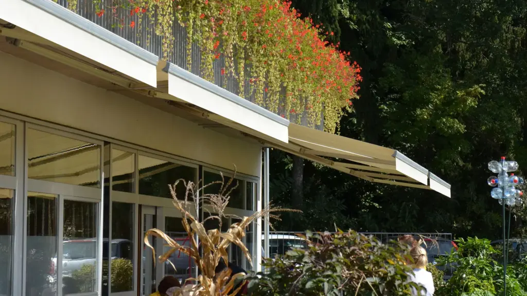 Offene WOUNDWO Markise über einer geschützten Terrasse